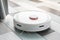 A robot vacuum cleaner helps in cleaning an apartment or house. Autonomous smart technologies.
