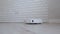 Robot vacuum cleaner vacuums the floor, move along wall and turns around. Low camera view