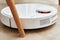 Robot vacuum cleaner working on floor with furniture, obstacles for robotic vacuum cleaner. Modern smart household