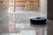 Robot vacuum cleaner working on kitchen floor