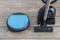 Robot vacuum and regular vacuum cleaner next to each other