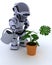 Robot with watering can feeding a plant