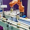 Robotic arm and cans on conveyor