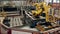 Robotic arm at factory floor sorts bricks on a conveyor.