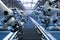 Robotic arms in aerospace engineering factory move down conveyor belt