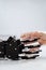 Robotic caregiver extending a hand with a glass of water to young woman