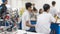 Robotic lab class with school students blur background learning in group having study workshop in science technology engineering