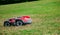 Robotic lawn mower on grass, side view. Garden modern remote technology