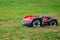 Robotic lawn mower on grass, side view. Garden modern remote technology