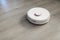 Robotic vacuum cleaner on laminate floor in action