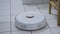 Robotic Vacuum Cleaner Roborock stopping and shutting down on white bathroom tiles