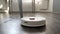 Robotic vacuum cleaner washes the floor in the apartment.