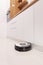 Robotic vacuum cleaner working on a kitchen