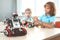 Robotics. Children having class making machine concentrated blurred robot close-up