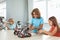 Robotics. Children having class playing robots fight smiling excited