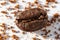 Robust coffee bean on the background of ground coffee on a white background, close-up. Robusta type of coffee beans