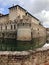 Rocca Sanvitale in Fontanellato, Parma, Italy across dramatic sky and water reflections. Medieval castle with moat