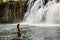 Rochester Falls and sexy woman in bikini. Amazing cascade waterfall in Mauritius