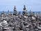 Rock art stacks and towers of grey stones and pebbles on a beach