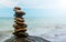 Rock balance. Stones placed one on top of the other, on the beach. The sea in the background