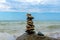 Rock balance. Stones placed one on top of the other, on the beach. The sea in the background