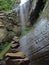 rock balance with waterfall in the background