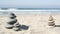 Rock balancing on ocean beach, stones stacking by sea water waves. Pyramid of pebbles on sandy shore