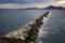Rock barrier interferes with wave pattern, at Naxos, Greece