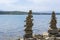 Rock cairn the art of stone balancing on a stone near a blue water flowing lake.