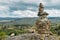 Rock cairn trail marker overlooking a valley in Northeastern Portugal, Europe