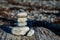 Rock Cairn on a weathered log at the beach at Boundary Bay, Blaine, Washington State