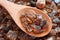 Rock cane sugar on a wooden spoon