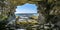 Rock cave on the sea with view of ocean and sky