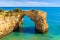 Rock cliff arch near Marinha beach