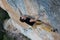 Rock climber ascending a challenging cliff. Extreme sport climbing. Freedom, risk, challenge, success