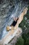 Rock climber ascending a challenging cliff. Extreme sport climbing. Freedom, risk, challenge, success. Sport and active life