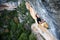 Rock climber ascending a challenging cliff. Extreme sport climbing. Freedom, risk, challenge, success. Sport and active life