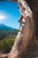 Rock climber on the background of beautiful mountains and blue sky