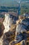 Rock climber in blue shirt climbing in Gora Zborow, Poland