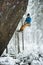 Rock climber on a challenging ascent. Extreme climbing. Unique winter sports. Scandinavian nature.