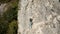 A rock climber climbs a category 5 route along a rock