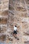 Rock climber climbs mountaneering wall