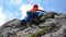 Rock climber dressed in bright colors on a steep granite climbing route in the Alps