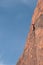 Rock climber high on cliff