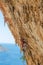 Rock climber lead climbing on challenging overhanging climbing route on tufa rocks