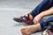 Rock climber puts on rocky shoes in a bouldering hall at a climbing gym