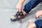 Rock climber puts on rocky shoes in a bouldering hall at a climbing gym