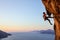 Rock climber resting while climbing cliff