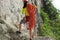 Rock climber standing with climbing gears