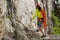 Rock climber standing in front of mountain cliff outdoor